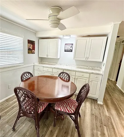 Dining space featuring light wood-type flooring and ceiling fan