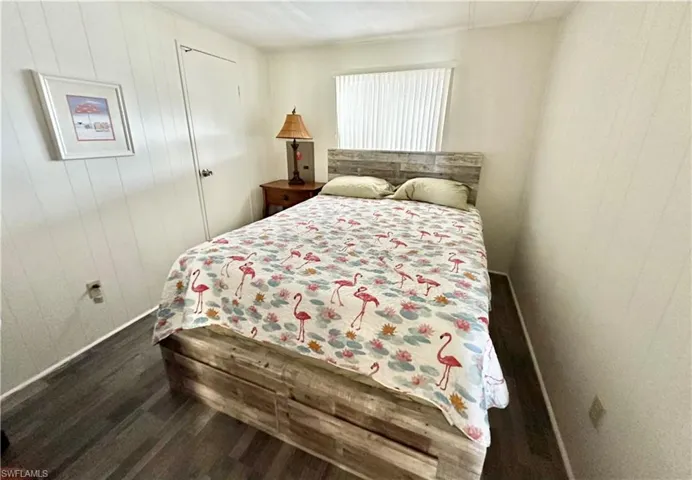 Bedroom with dark hardwood / wood-style floors