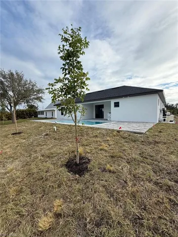 Back of property with a yard and a patio