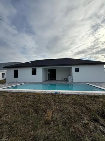 View of swimming pool with a yard