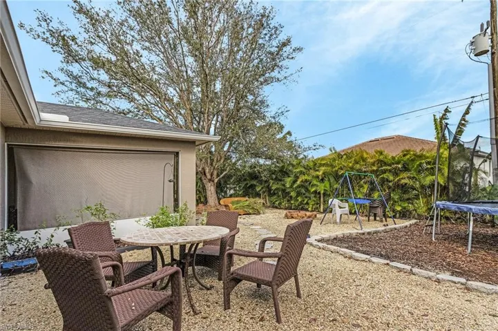 View of patio / terrace featuring a trampoline and outdoor dining area