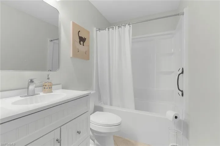 Full bath with shower / tub combo, vanity, and toilet