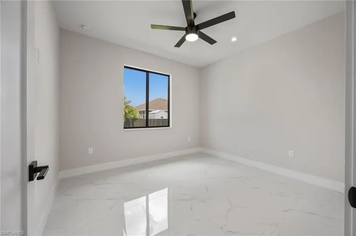 Unfurnished room featuring light marble finish floors, ceiling fan, and recessed lighting