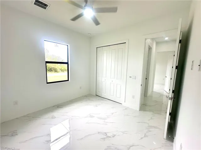 Unfurnished bedroom with a closet and ceiling fan