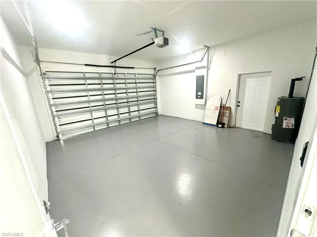Garage with a garage door opener and electric water heater