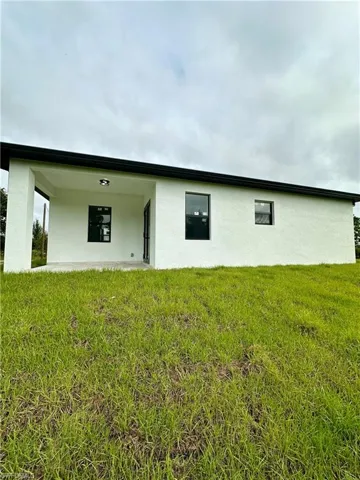 Rear view of house with a yard