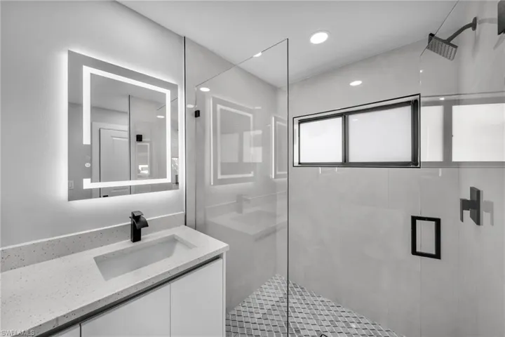 Bathroom with a shower with door and vanity