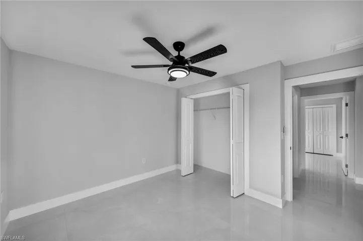 Unfurnished bedroom featuring a closet and ceiling fan