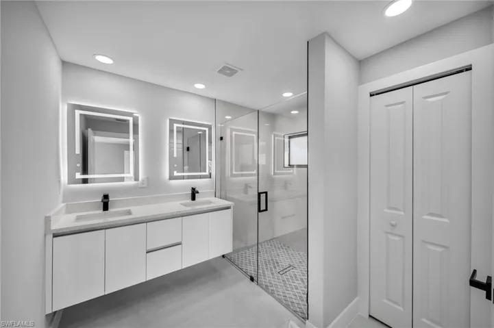Bathroom featuring vanity and a shower with shower door