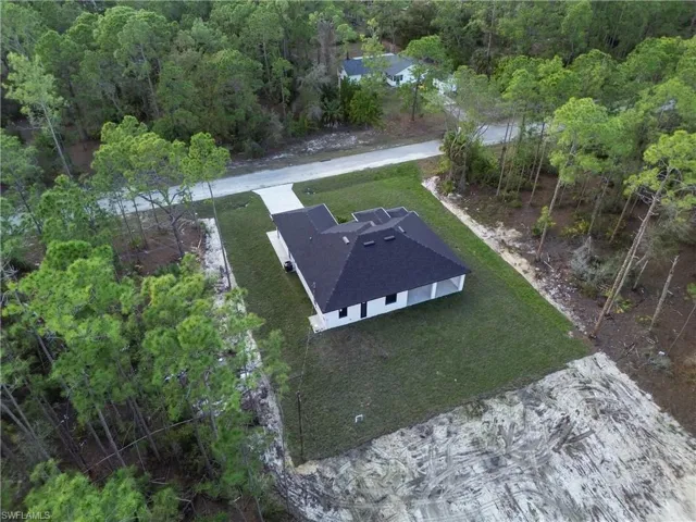 Drone / aerial view featuring a wooded view