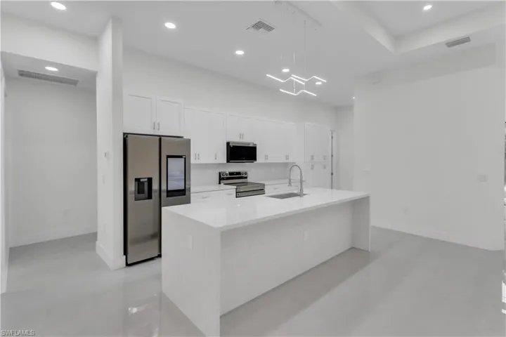 Kitchen featuring visible vents, stainless steel appliances, and a sink