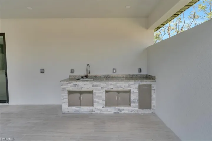 View of patio / terrace with an outdoor kitchen and a sink