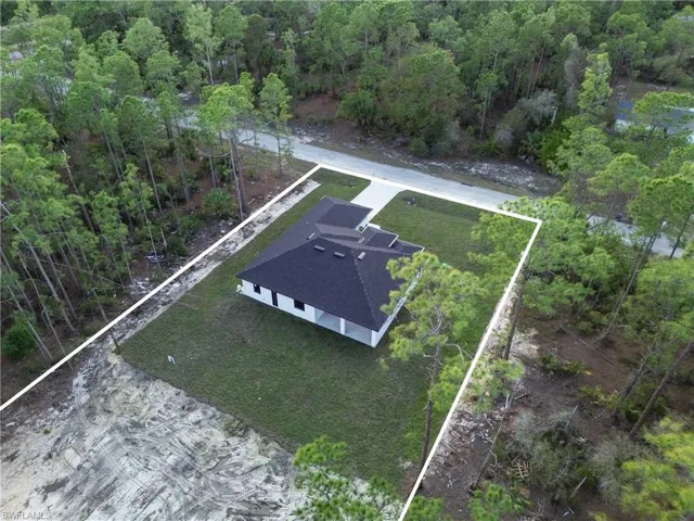 Aerial view featuring a view of trees