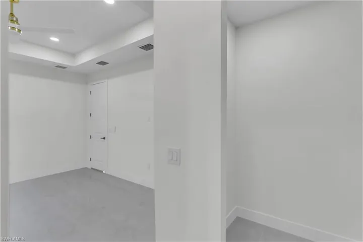 Empty room featuring baseboards and visible vents