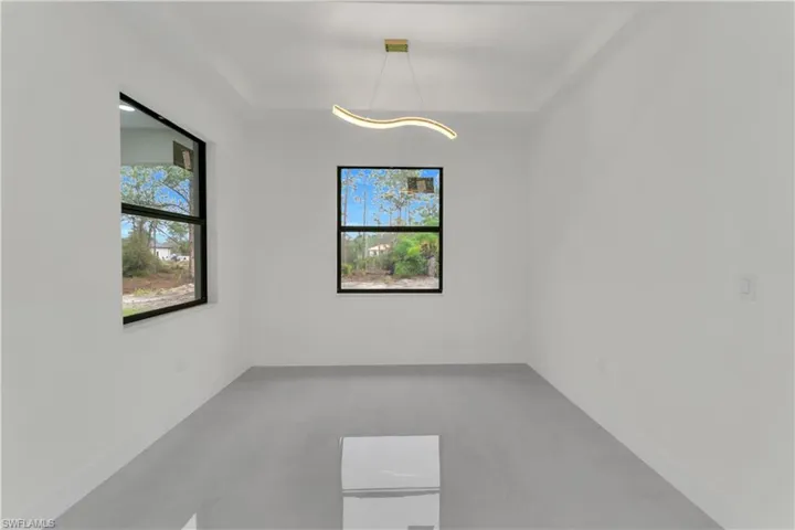 Empty room with a tray ceiling and a healthy amount of sunlight