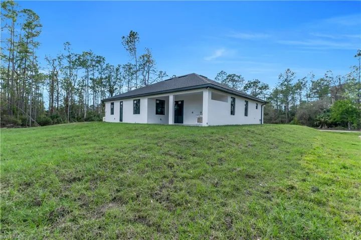 Ranch-style home with a front lawn and stucco siding