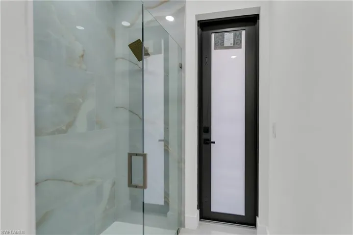Bathroom with a marble finish shower