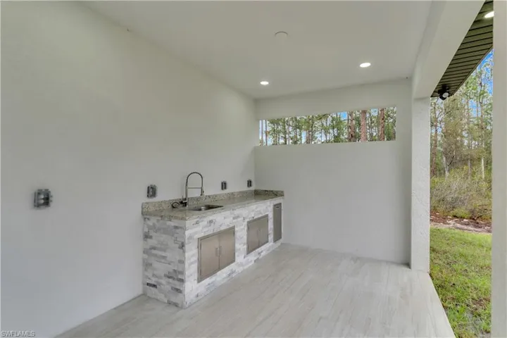 View of patio / terrace featuring an outdoor kitchen and a sink