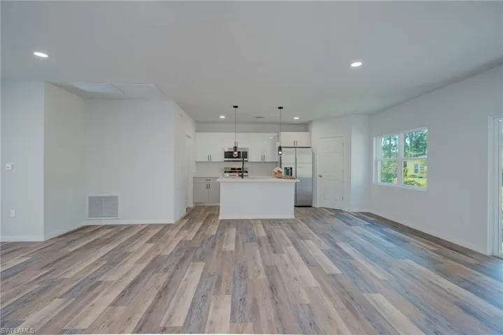 Unfurnished living room featuring light wood-style floors and recessed lighting