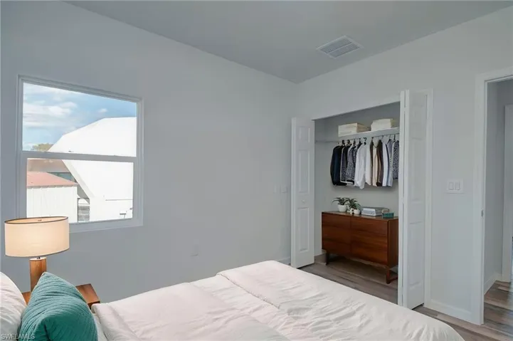 Bedroom with a closet and wood finished floors
