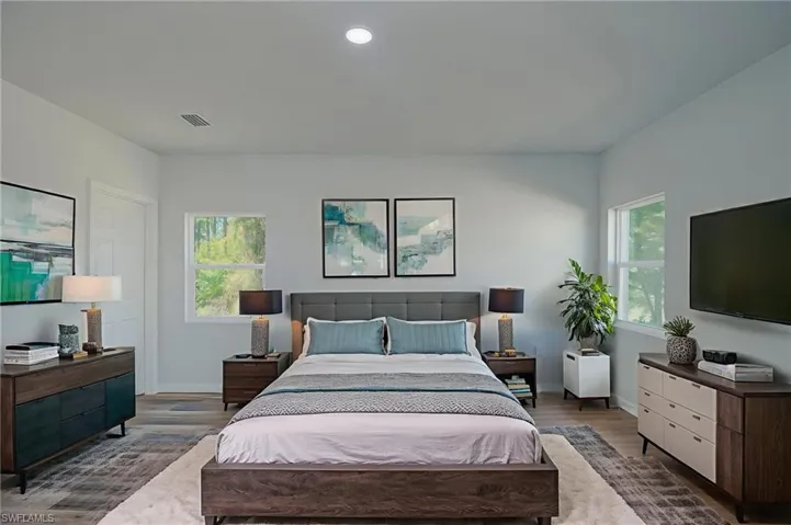 Bedroom featuring wood finished floors and recessed lighting