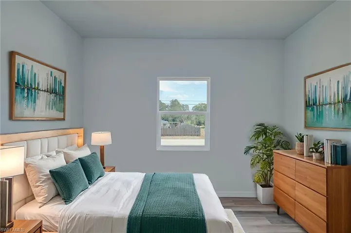 Bedroom with light wood-type flooring and baseboards