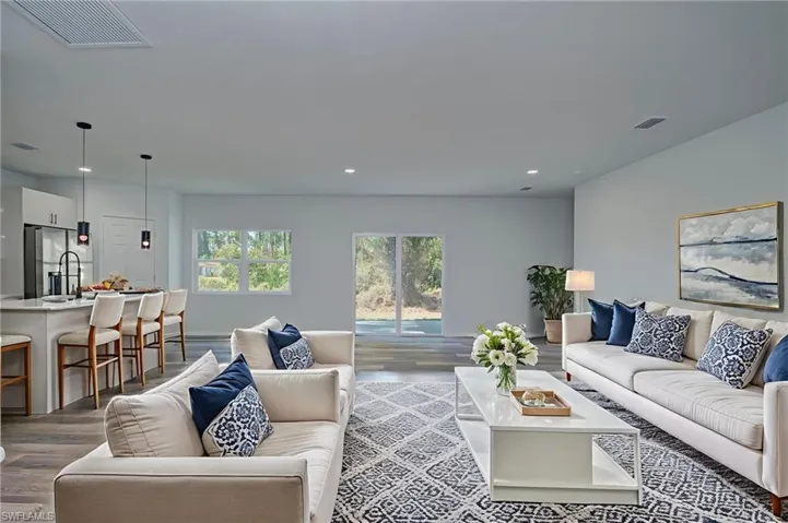 Living room with wood finished floors and recessed lighting