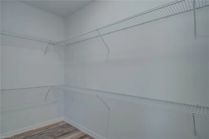 Spacious closet featuring wood finished floors