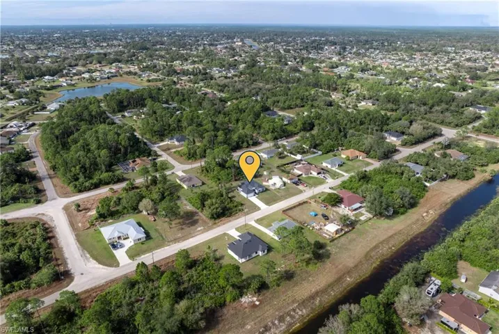 Aerial overview of property's location featuring a large body of water and nearby suburban area