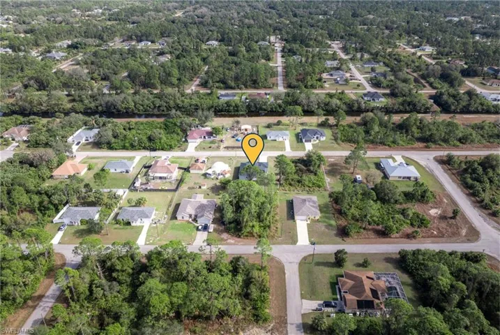 Aerial view of property's location with nearby suburban area