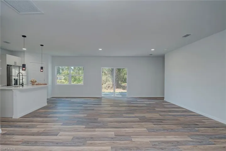 Unfurnished living room with light wood-style flooring and recessed lighting