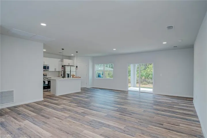 Unfurnished living room with light wood-style floors and recessed lighting