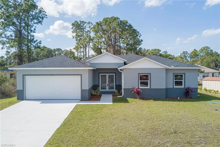 Ranch-style home featuring french doors, a front lawn, stucco siding, driveway, and a shingled roof