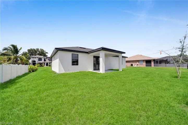 Back of property with a patio area and stucco siding