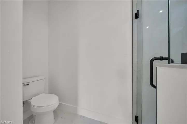 Bathroom featuring a stall shower and toilet