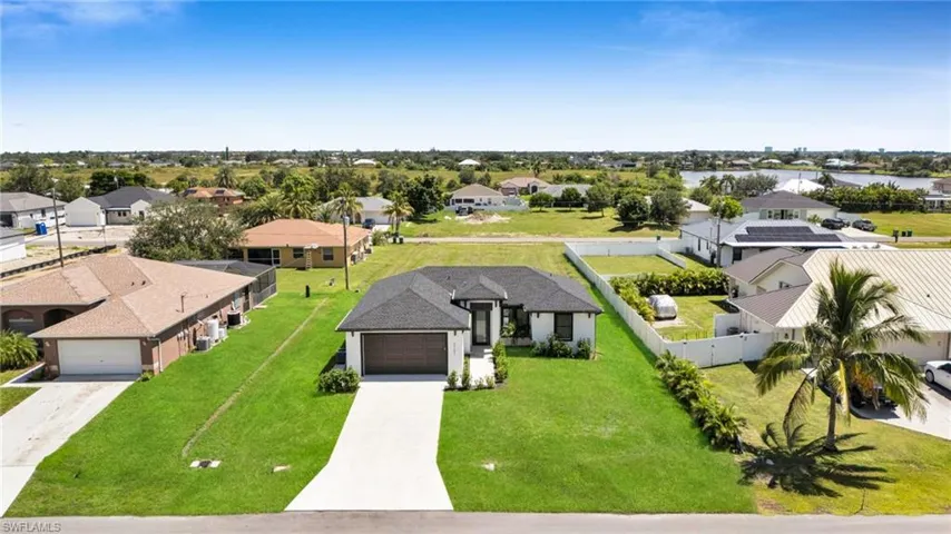 Aerial perspective of suburban area with a nearby body of water