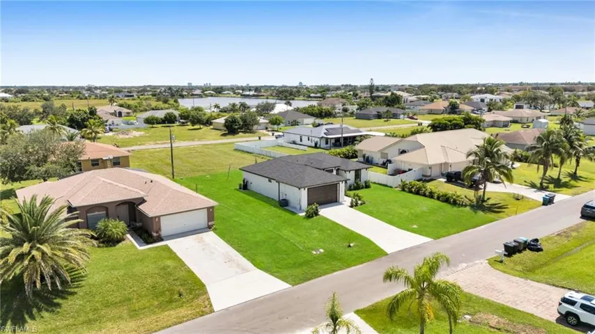 Aerial view of residential area featuring a large body of water