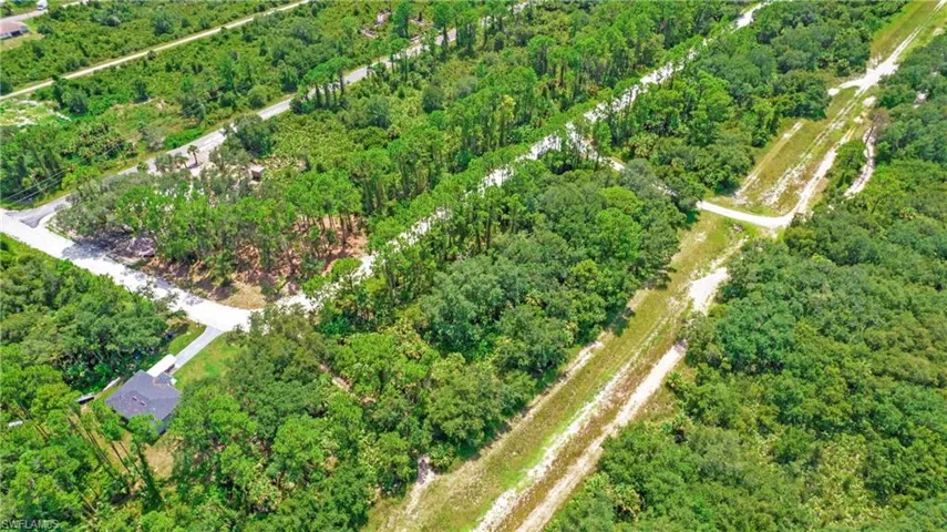 Aerial overview of property's location featuring a forest