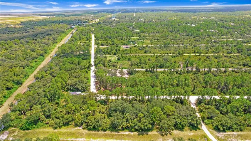 Aerial overview of property's location featuring a heavily wooded area