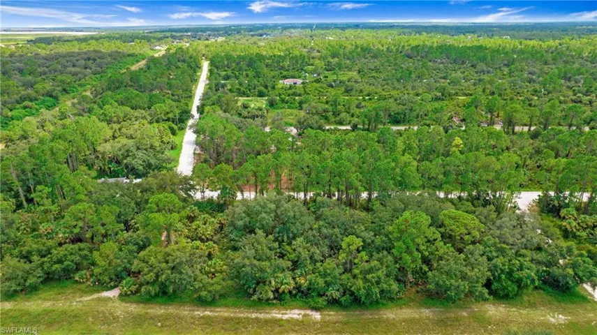 View of property location featuring a heavily wooded area