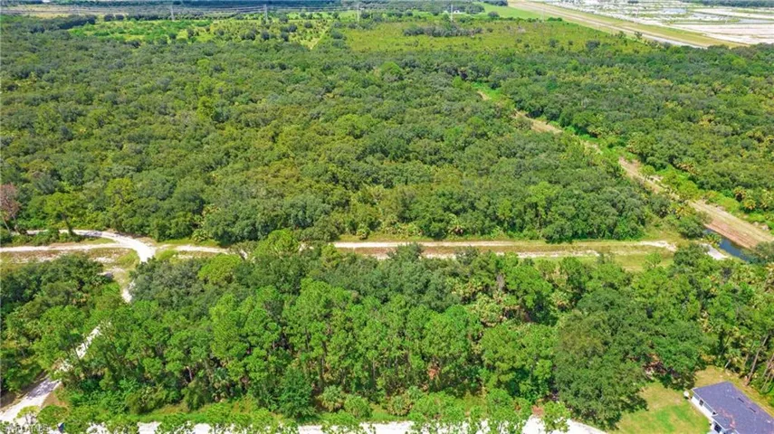 Aerial view of property's location with a heavily wooded area
