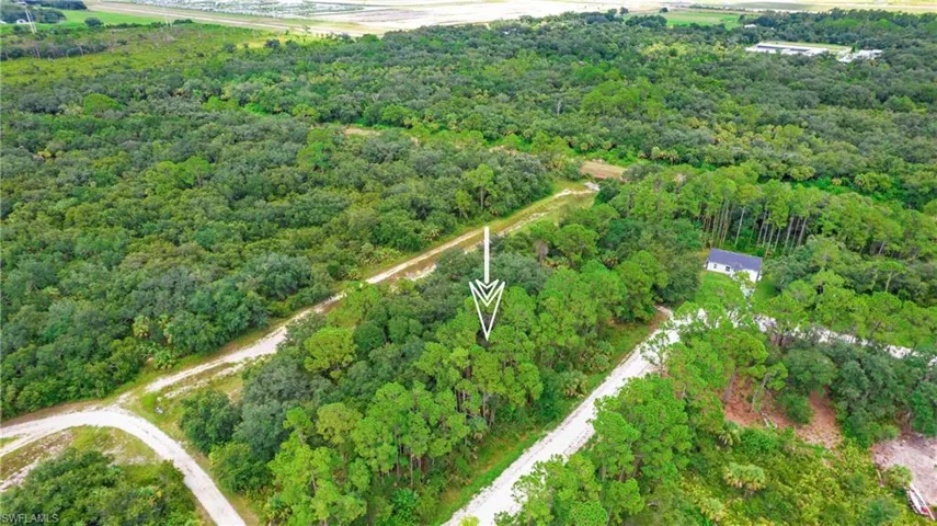 View of property location featuring a forest