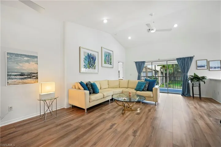 Living area featuring a ceiling fan, light wood-style floors, recessed lighting, and high vaulted ceiling