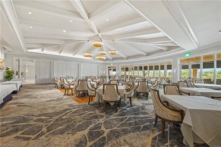 Dining area featuring beam ceiling, recessed lighting, and a chandelier