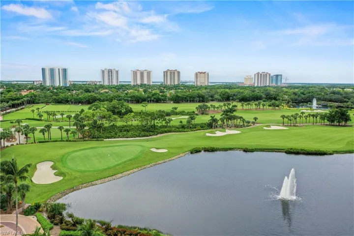 View of home's community with view of scattered trees, a water view, and view of golf course