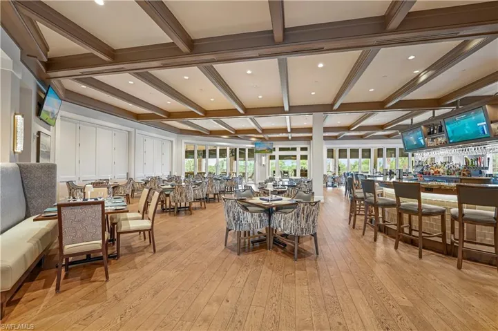 Dining room with beam ceiling, coffered ceiling, light wood-style flooring, and recessed lighting