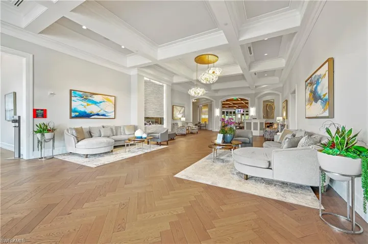 Community lobby featuring beam ceiling, coffered ceiling, a high ceiling, and crown molding
