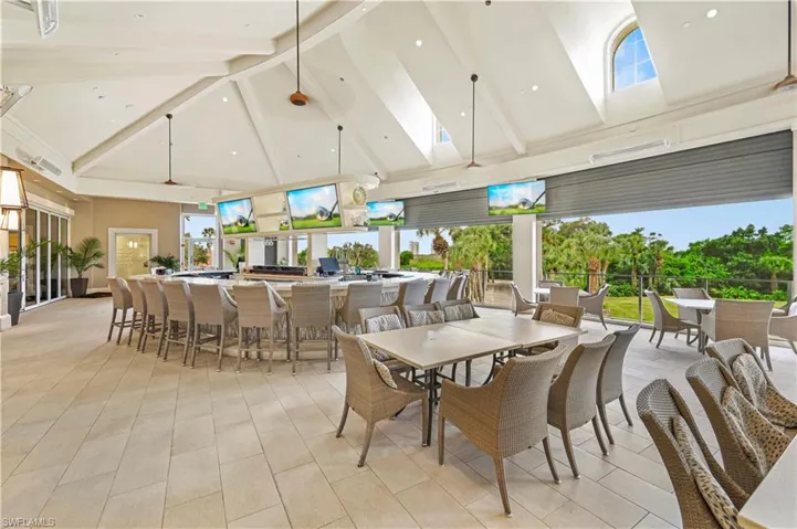 Dining room featuring high vaulted ceiling and beam ceiling