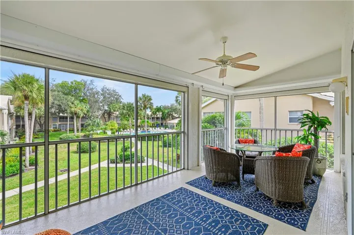Sunroom / solarium with vaulted ceiling, a ceiling fan, and healthy amount of natural light