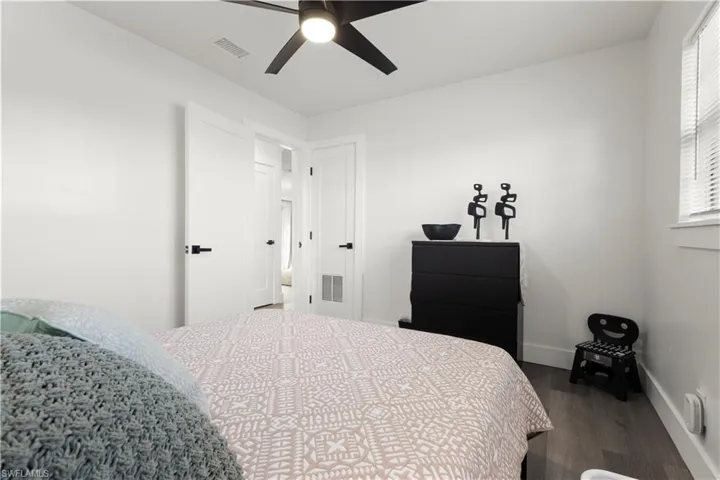 Bedroom with ceiling fan and wood-type flooring